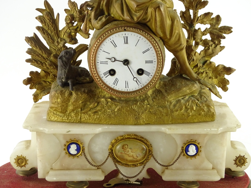 A late 19thC gilt metal mantel clock, the 8cm diameter Roman numeric dial surmounted by a figure of - Image 2 of 3