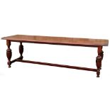 A large mahogany refectory type table, rectangular top with a moulded edge and cleated ends, on cup
