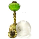 A Victorian brass oil lamp, with a green glass reservoir, and a part frosted shade, the base 38cm hi