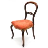 A Victorian rosewood balloon back chair, with a pierced rail and padded seat, on cabriole legs.