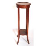 An Edwardian walnut two tier plant stand, with a circular dished top on plain splayed supports, 92cm