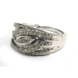 A 9ct white gold dress ring, set with arrangement of round brilliant and baguette cut diamonds, on t