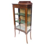 An Edwardian mahogany boxwood strung display cabinet, with a single glazed door, decorated centrally