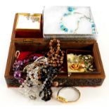 A carved wooden jewellery box and contents, comprising modern necklaces, silver crucifix pendant and