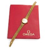 A 9ct gold Omega ladies wristwatch, with small silvered dial, on a four row weave design bracelet, 1