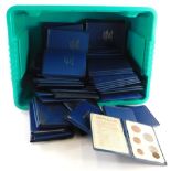 A large quantity of British decimal coin sets, each in original blue plastic folders.