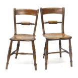 A pair of 19thC Oxfordshire bar back kitchen chairs, each with a solid seat on turned tapering legs,