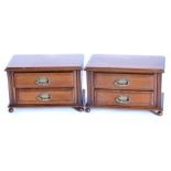 A pair of walnut small chest of drawers, each with a moulded top above two drawers on bun feet, 43.5
