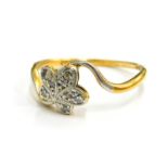 An 18ct gold and platinum leaf design dress ring, with single five leaf set with tiny diamonds, on a