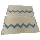 A pair of South African flatweave rugs, each with a blue zig-zag design on a beige ground, 124cm x 7