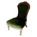 A Victorian walnut nursing chair, with a show frame, green fabric padded back and seat on turned tap