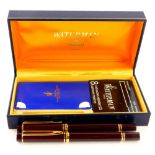 A Waterman's ideal pen set, comprising two fountain pens each in burgundy, with gilt trim in a Water