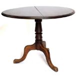 A 19thC mahogany tilt top occasional table, the circular top with a moulded edge, on a turned column