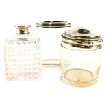 Three silver mounted glass jars, a cylindrical example with domed silver lid, an oval example with e