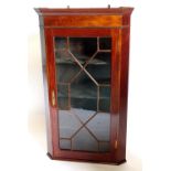 An early 19thC mahogany hanging corner cabinet, with a single astragal glazed door, 108cm high, 65cm