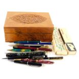 An early 20thC Eastern box with heavily carved top, containing a quantity of pens, ballpoint pens, M