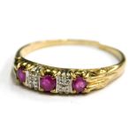 A ruby and diamond set dress ring, set with three rubies and four diamonds, in channel type setting,