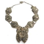 An Eastern style filigree necklace, of encrusted design with butterfly detail, white metal, stamped