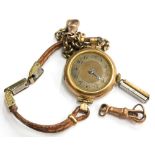 A 9ct gold wristwatch, with 9ct gold circular watch head, lacking glass, on a brown two strap bracel