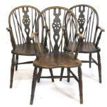 A set of three late 19th-early 20thC beech ash and elm Windsor chairs, each with a wheel shaped spla