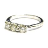 A platinum diamond three stone set dress ring, with three round brilliant cut diamonds, each similar