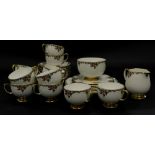 A Carltonware part tea service, decorated with flowers, embellished with coloured enamel jewel work,