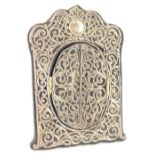 An unusual silver mounted velvet photograph frame, decorated with scrolls, and pierced work around a