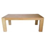 An oak dining table, the rectangular planked top with recesses for the legs to each corner, above a