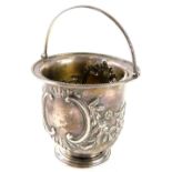 A silver sugar basket, with beaded handle and border, embossed with c scrolls, flowers and leaves, e