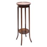 An Edwardian mahogany and boxwood strung two tier plant stand, the circular dished top with a centra