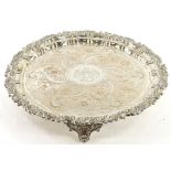 A large silver plated salver, engraved centrally with an elaborate armorial within shell and scroll