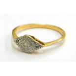 An Art Deco 18ct gold and platinum ring, the ring head in a marquise shape set with three tiny diamo