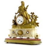 A late 19thC gilt metal mantel clock, the 8cm diameter Roman numeric dial surmounted by a figure of