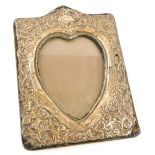 An Edwardian silver mounted rectangular photograph frame, with heart shaped aperture, (AF), 19.5cm