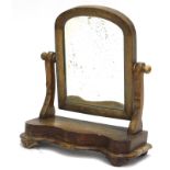A Victorian walnut dressing table mirror, with shaped supports, and serpentine fronted base, on bun