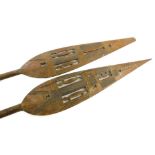 A matched pair of early 20thC African Tribal paddles, each with pierced blades, shaped stems and tur