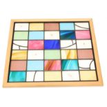 A modern stained glass panel, constructed from rectangular coloured panels with leaded borders etc.,