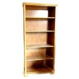 A pine open bookcase, with four adjustable shelves, on bracket feet, 192cm high, 89cm wide.