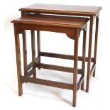 A nest of two mahogany occasional tables, each with a rectangular moulded top, and plain supports, t
