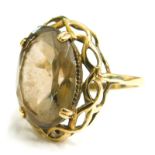 A 9ct gold chunky design smoky quartz dress ring, set with oval cut smoky quartz in four claw settin