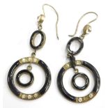 A pair of black enamel and paste stone set drop earrings, with design of circles, silver plated.