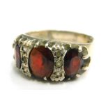 A stone set silver dress ring, set with red and white stones, in a gypsy style setting, ring size P,