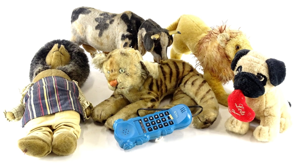 A collection of children's toys, to include a battery operated mechanical cow, a Tyco telephone mode