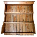 A reclaimed pine dresser base back, with moulded cornice above two shelves, with shaped end supports