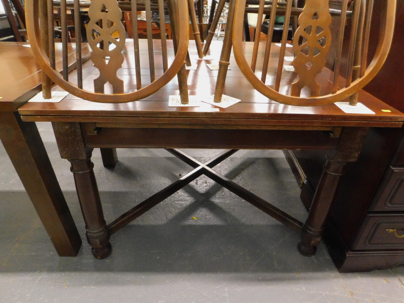 A mahogany extending dining table, on 'X' shaped stretcher.