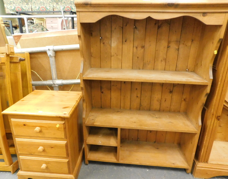 A pine hanging shelf and a pine three drawer bedside table. (2)