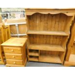 A pine hanging shelf and a pine three drawer bedside table. (2)