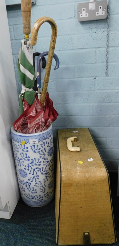 A cased sewing machine, blue and white ceramic umbrella stand, various umbrellas, etc. (a quantity).