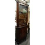 A mahogany glazed front corner cabinet.