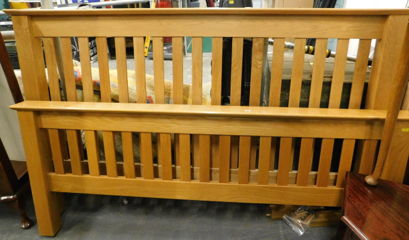 A modern oak double bed head and foot board, various slats, etc.(a quantity)